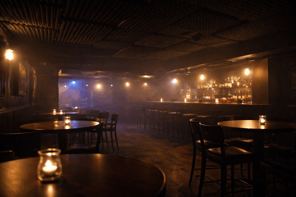Empty basement bar interior with acoustic foam-style ceiling panels and low lighting, highlighting how smoke could spread quickly.