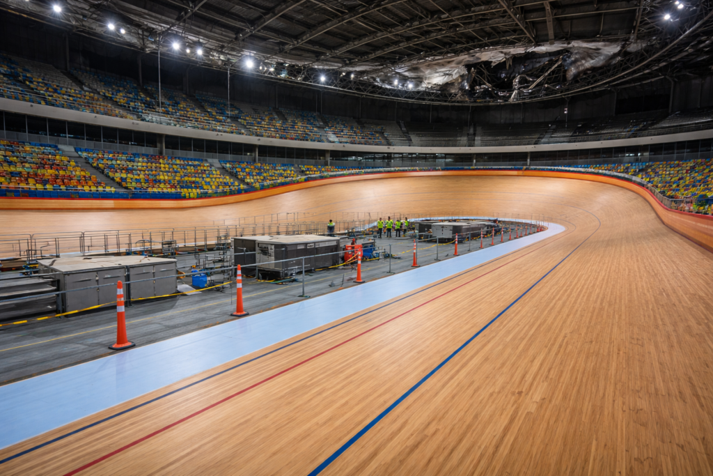 Interior view of a velodrome track undergoing inspection after a fire at the venue